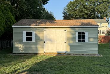 Sage shed pictured from a front angle, lighted with warm summer light.