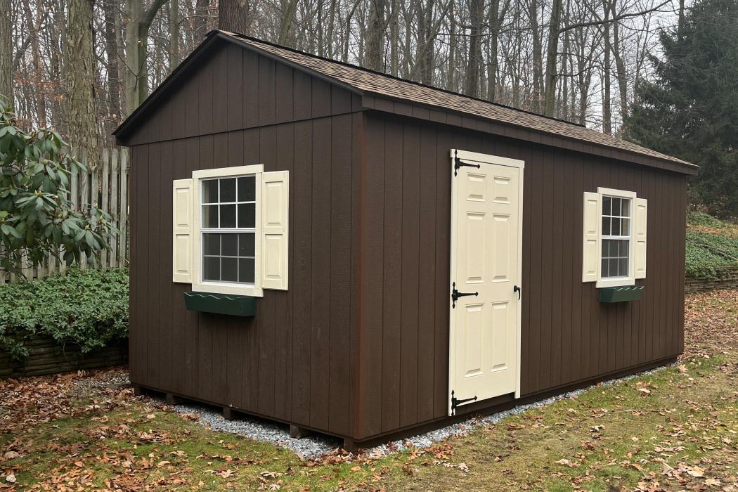 window and door side view of two-tone shed.