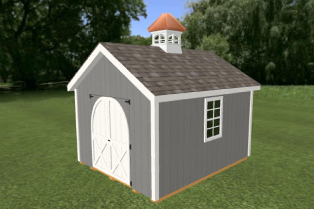 A small shed on grass with custom cupola and gray siding