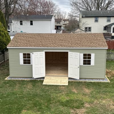 Sage colored shed front view with doors open.