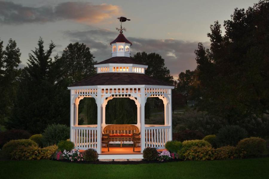 white vinyl gazebo lighted up at sunset