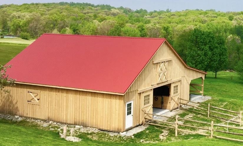 equine shed with red roof and board and batten siding