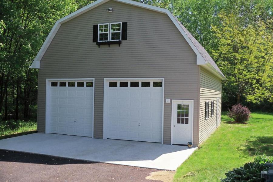 Custom 2 story garage shed with hip roof and 2 garage doors